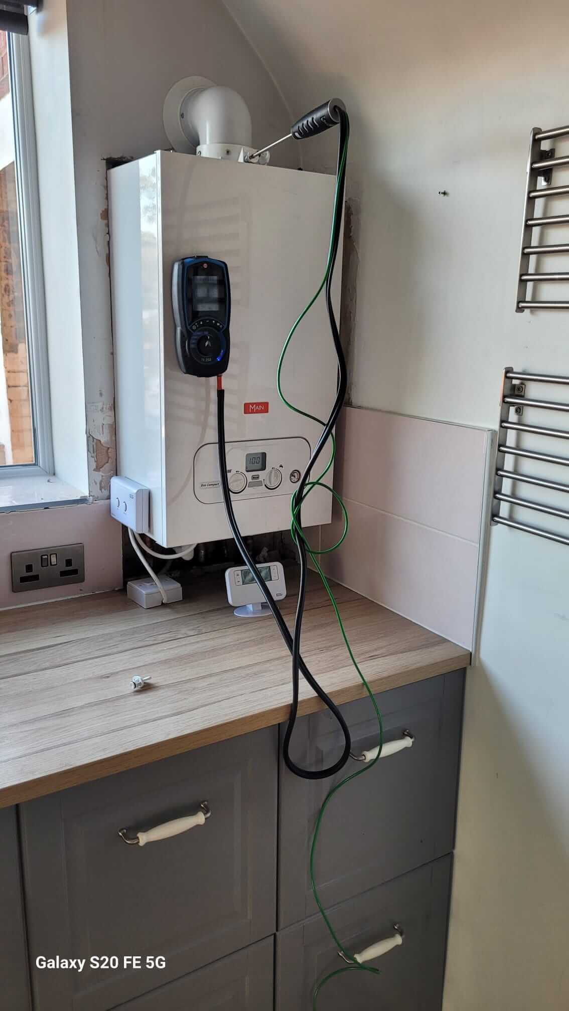 Main boiler with a flue analyser connected during testing