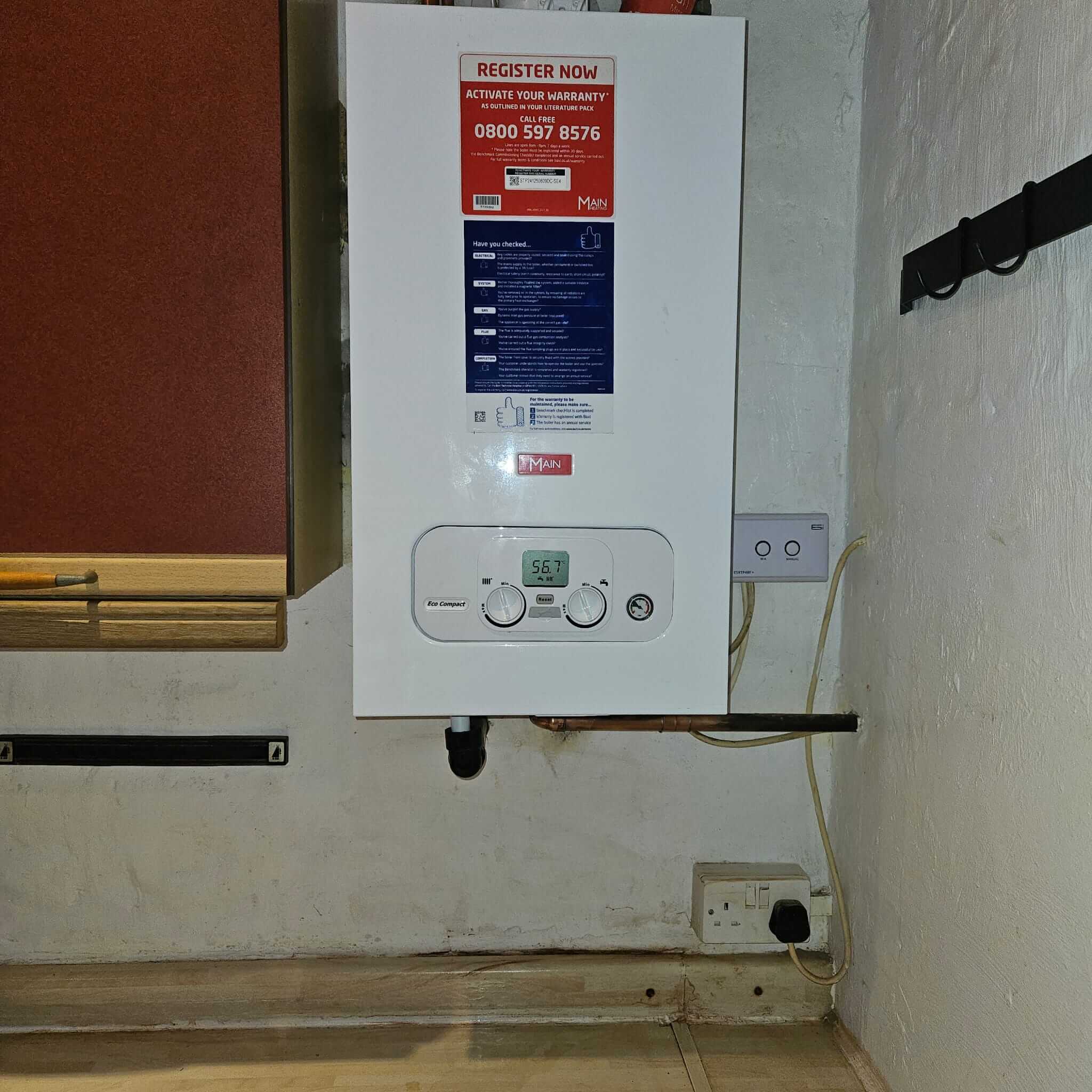 Main Eco Compact boiler mounted beside a kitchen cabinet