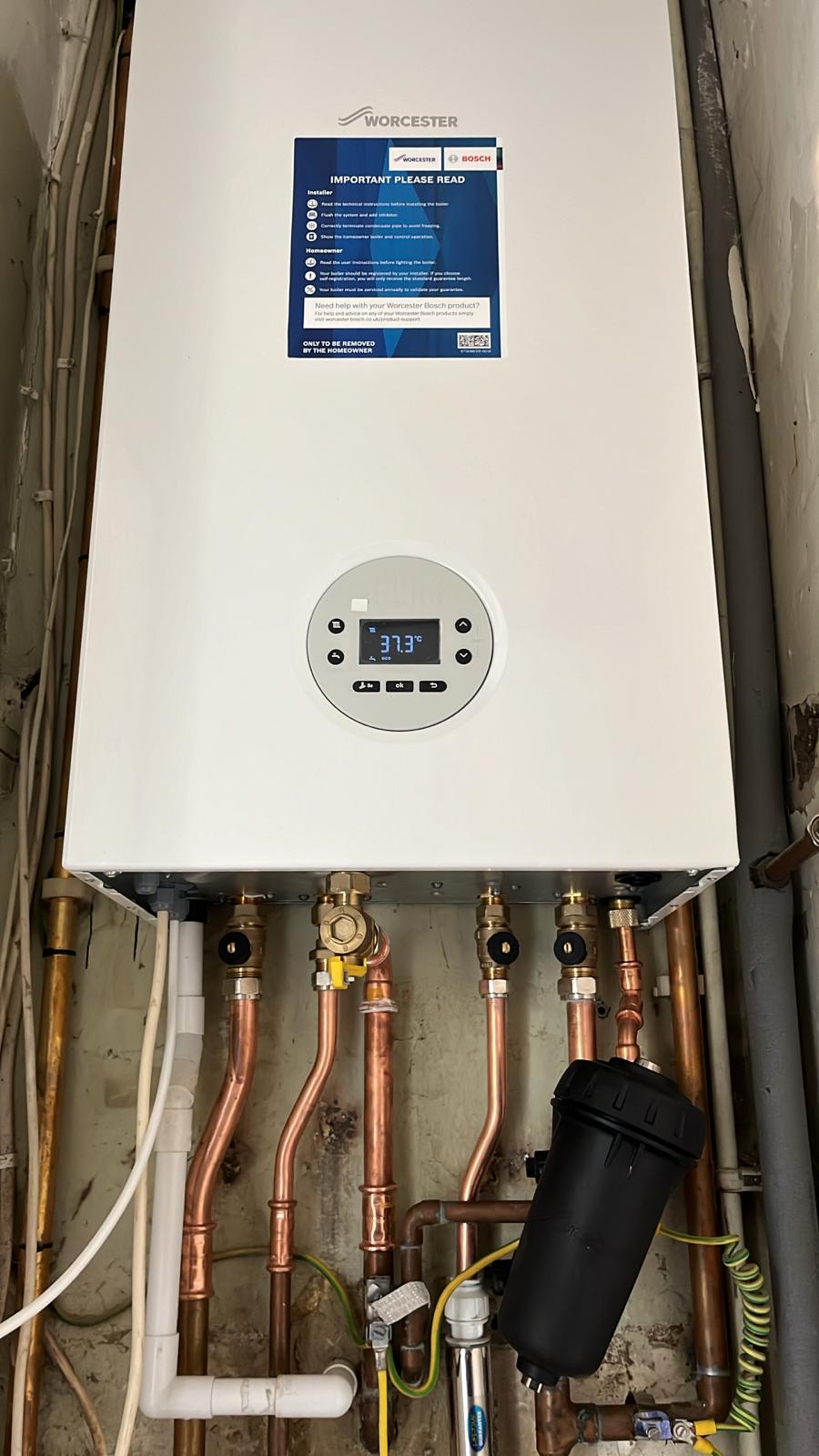 Worcester Bosch wall-mounted boiler with copper pipework and a magnetic filter